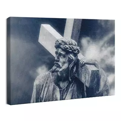 Obraz drukowany na płótnie Kamienna rzeźba Jezusa z krzyżem i niebo
